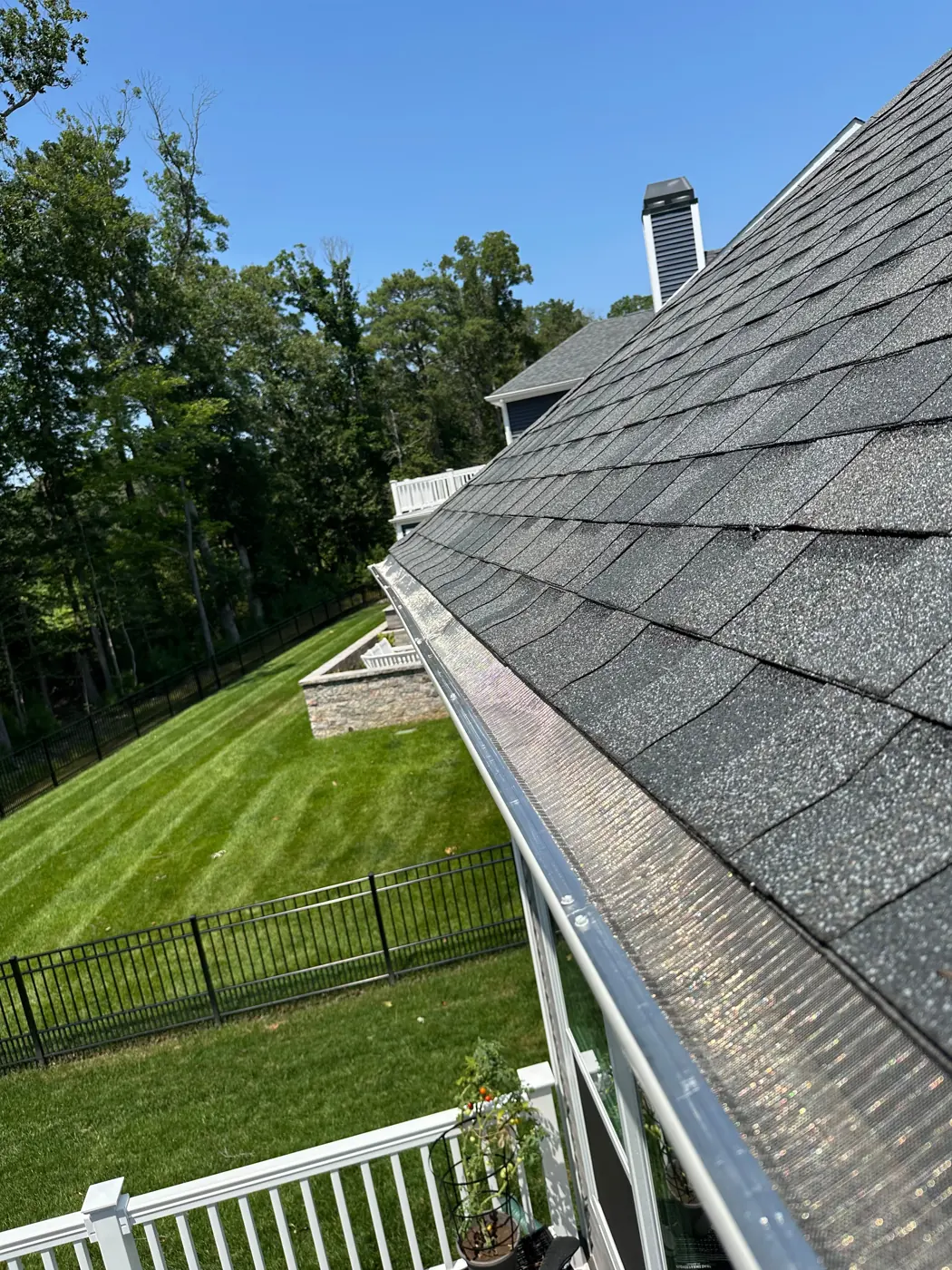 Gutter guards on a newer home with a large yard
