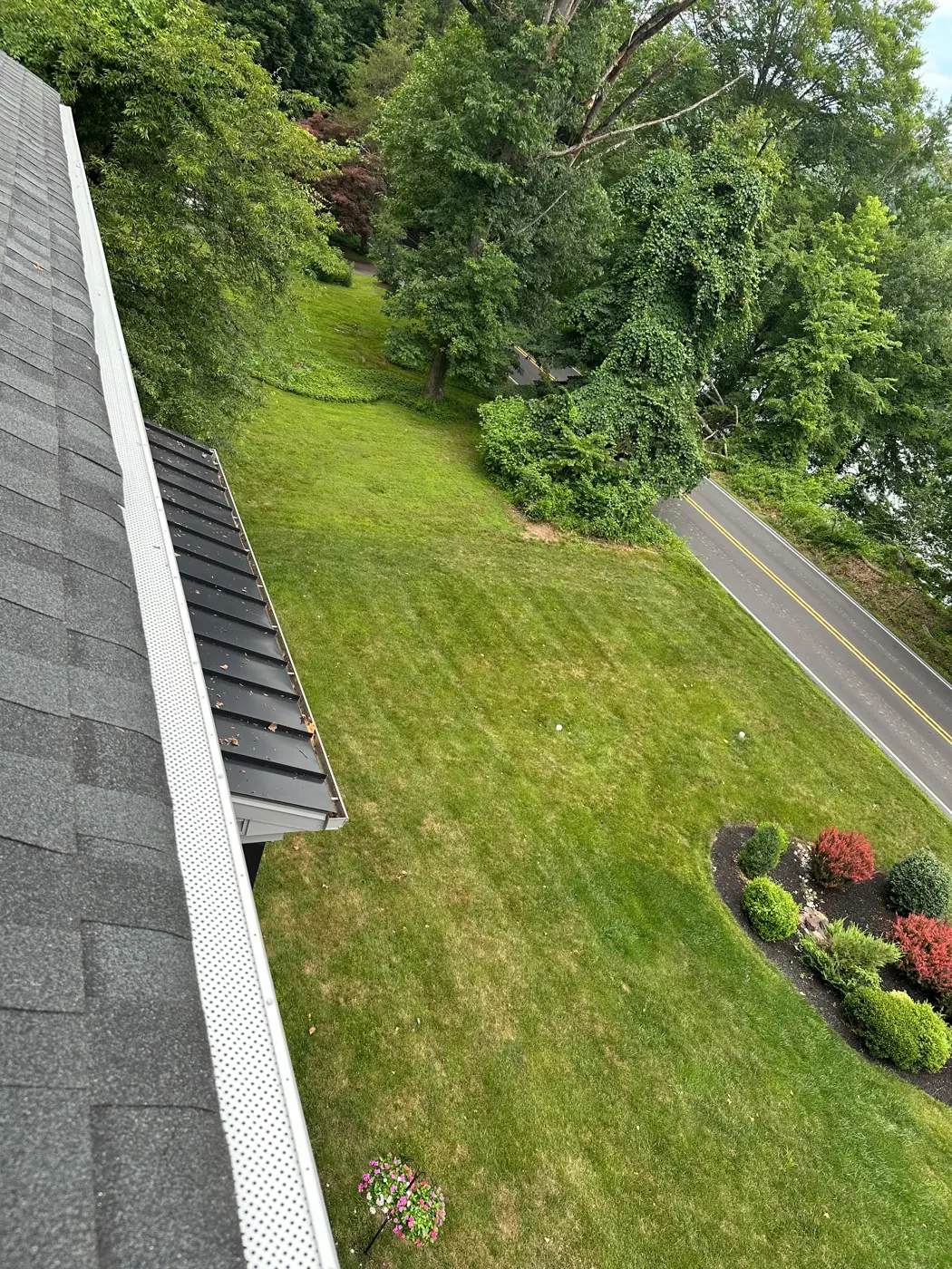 Gutter guards installed on a home backing onto woods