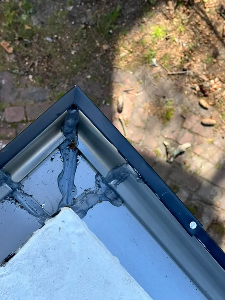 Sealed mitered corner on a black seamless gutter