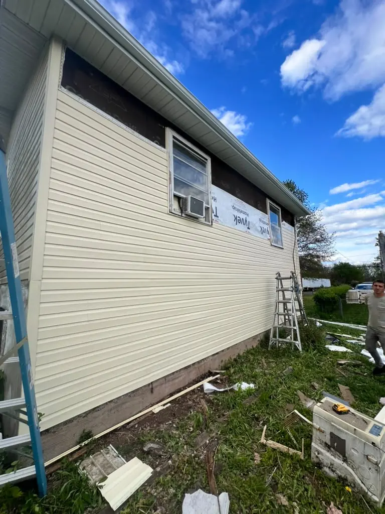 New vinyl siding going up on a side wall