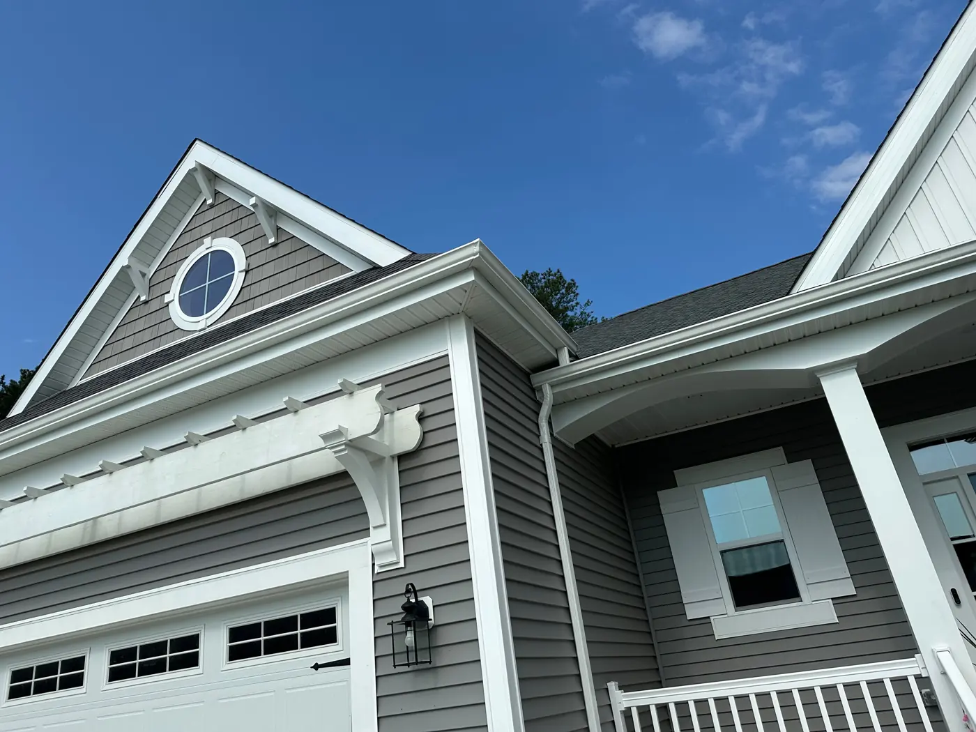 Gray siding and white trim on a newer home