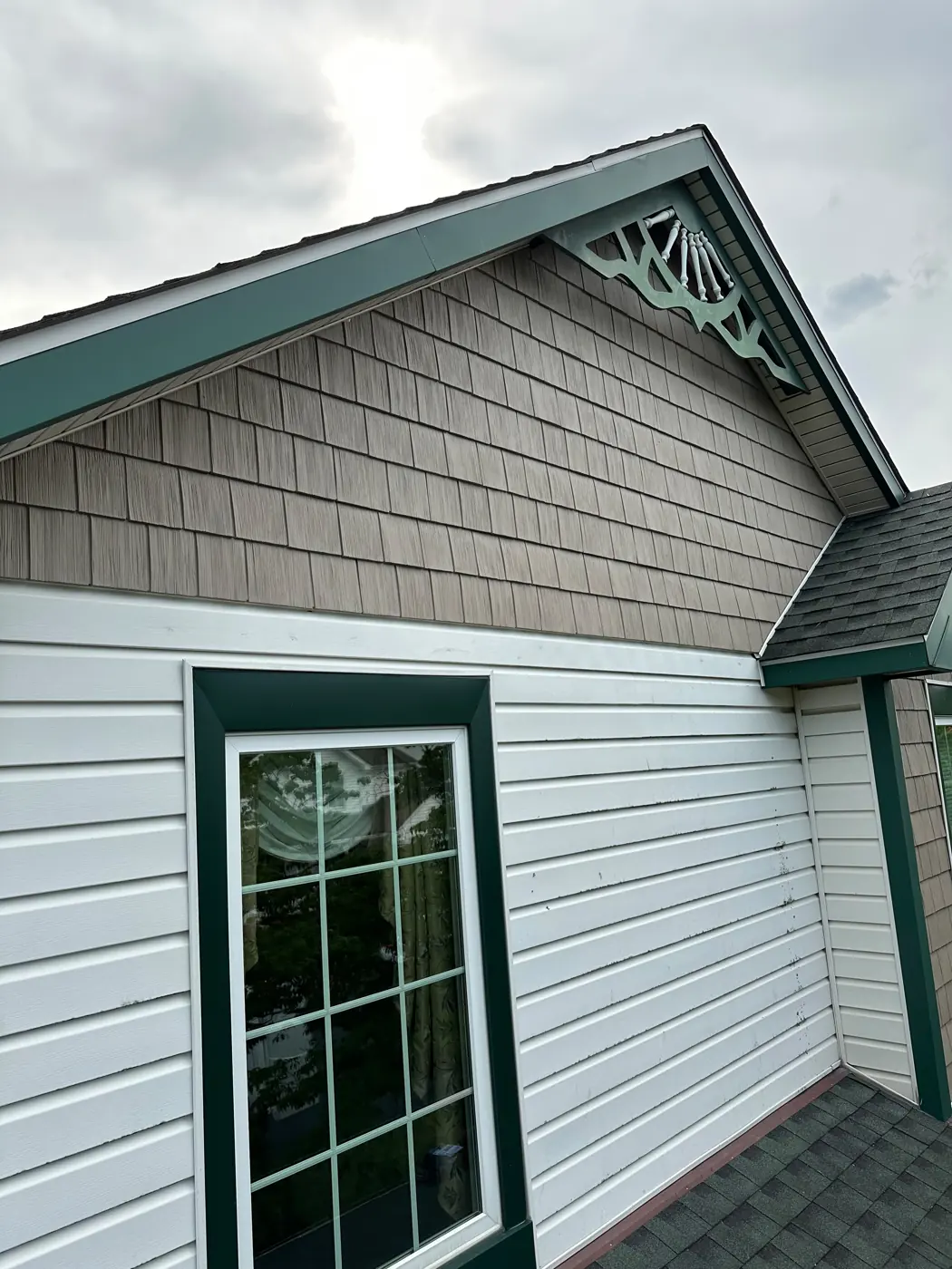 Finished white lap siding with shake-style gable