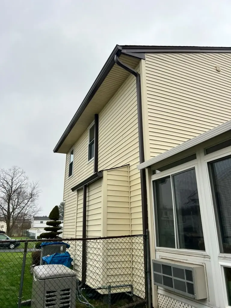 Two-story home with new gutters and downspouts